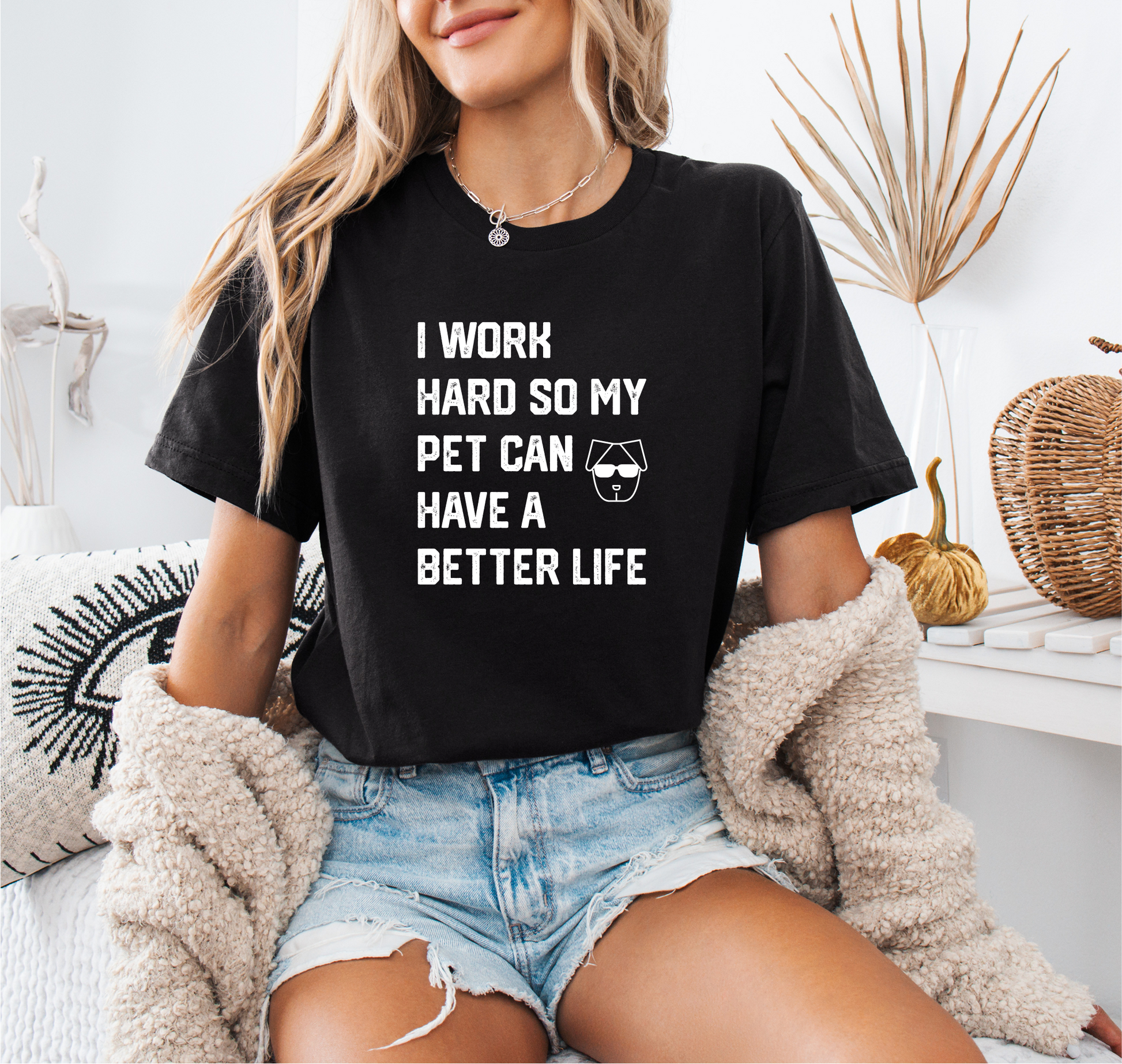 a woman sitting on a bed wearing a t - shirt that says i work hard