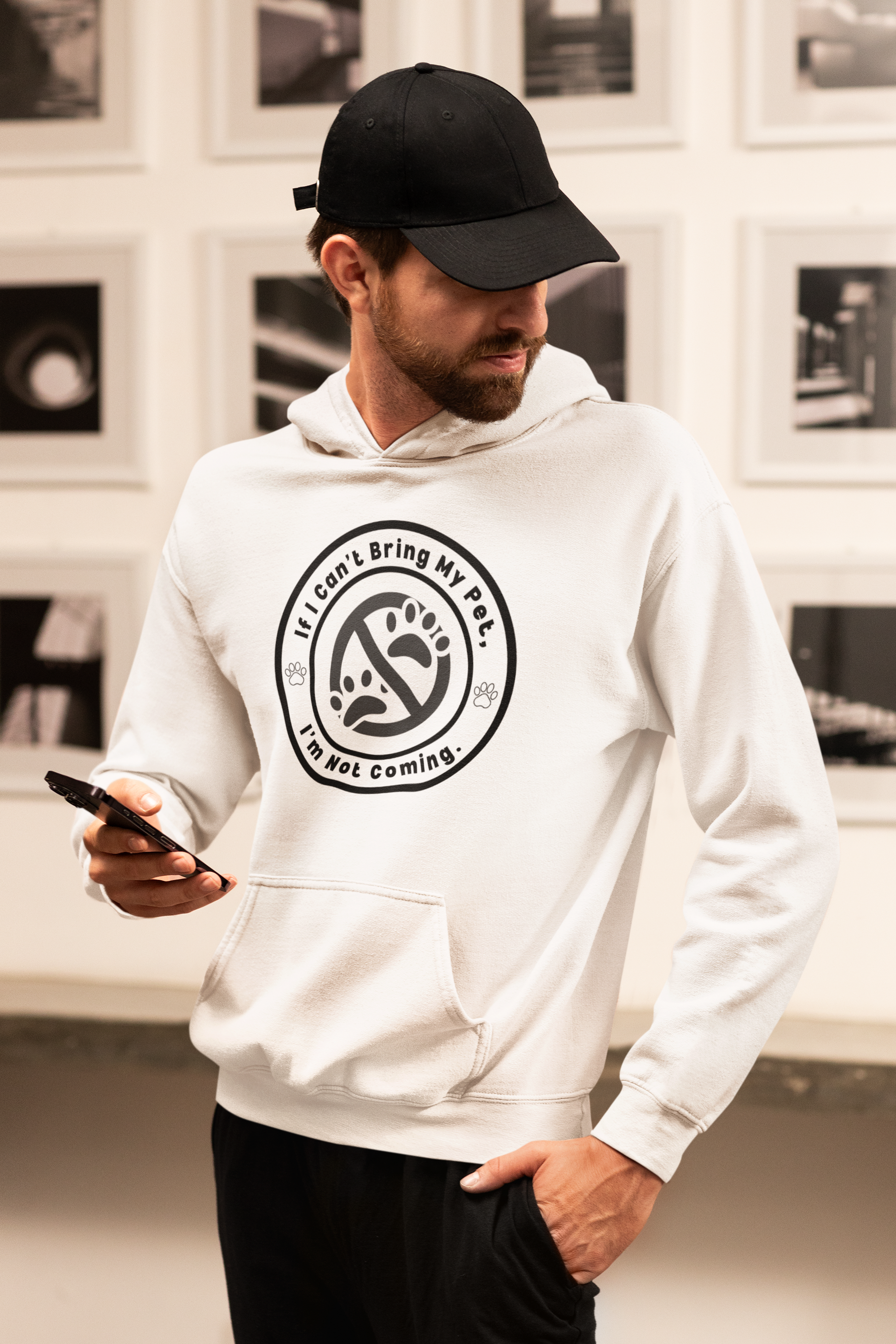 a man in a white hoodie looking at his cell phone