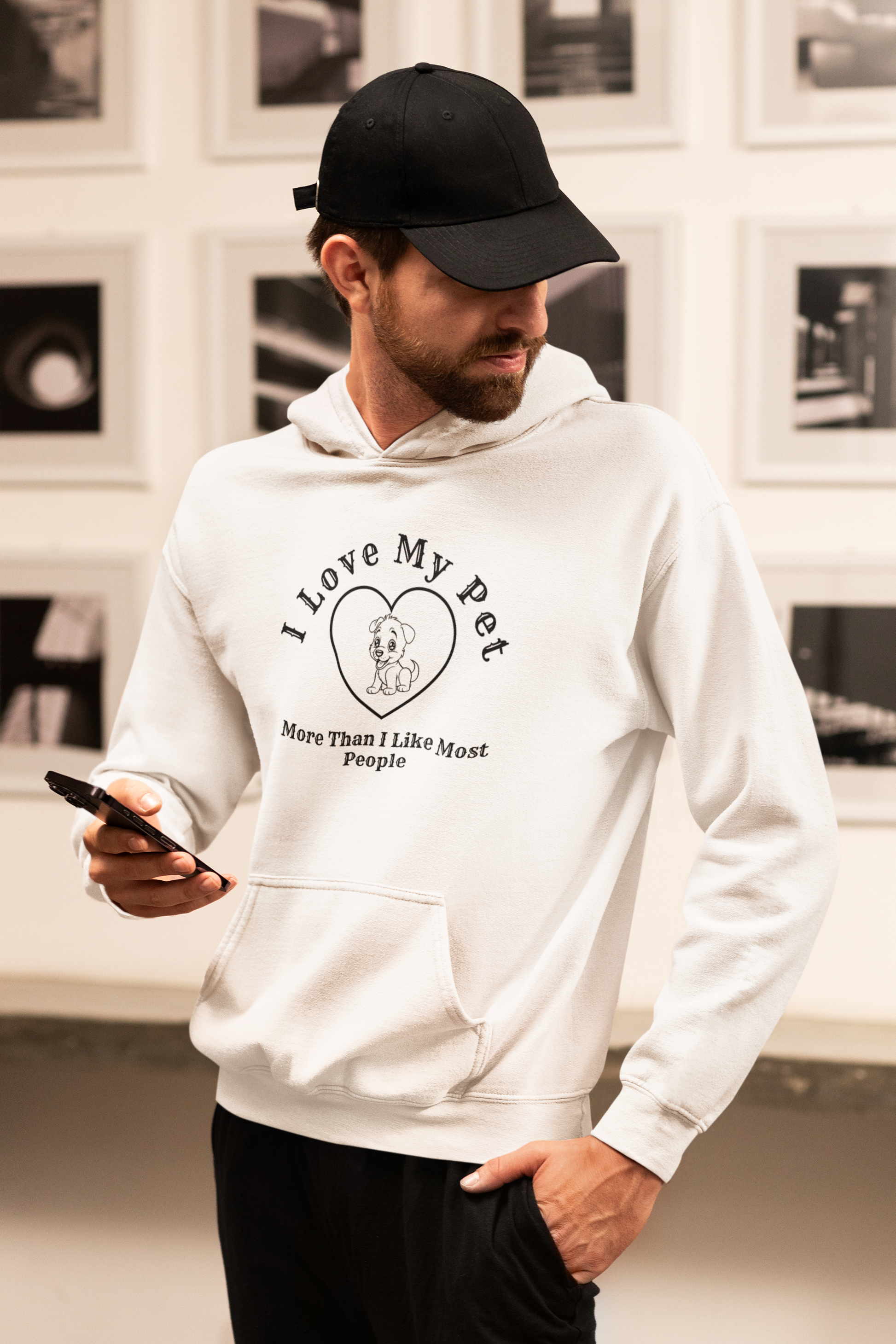 a man in a white hoodie looking at his cell phone