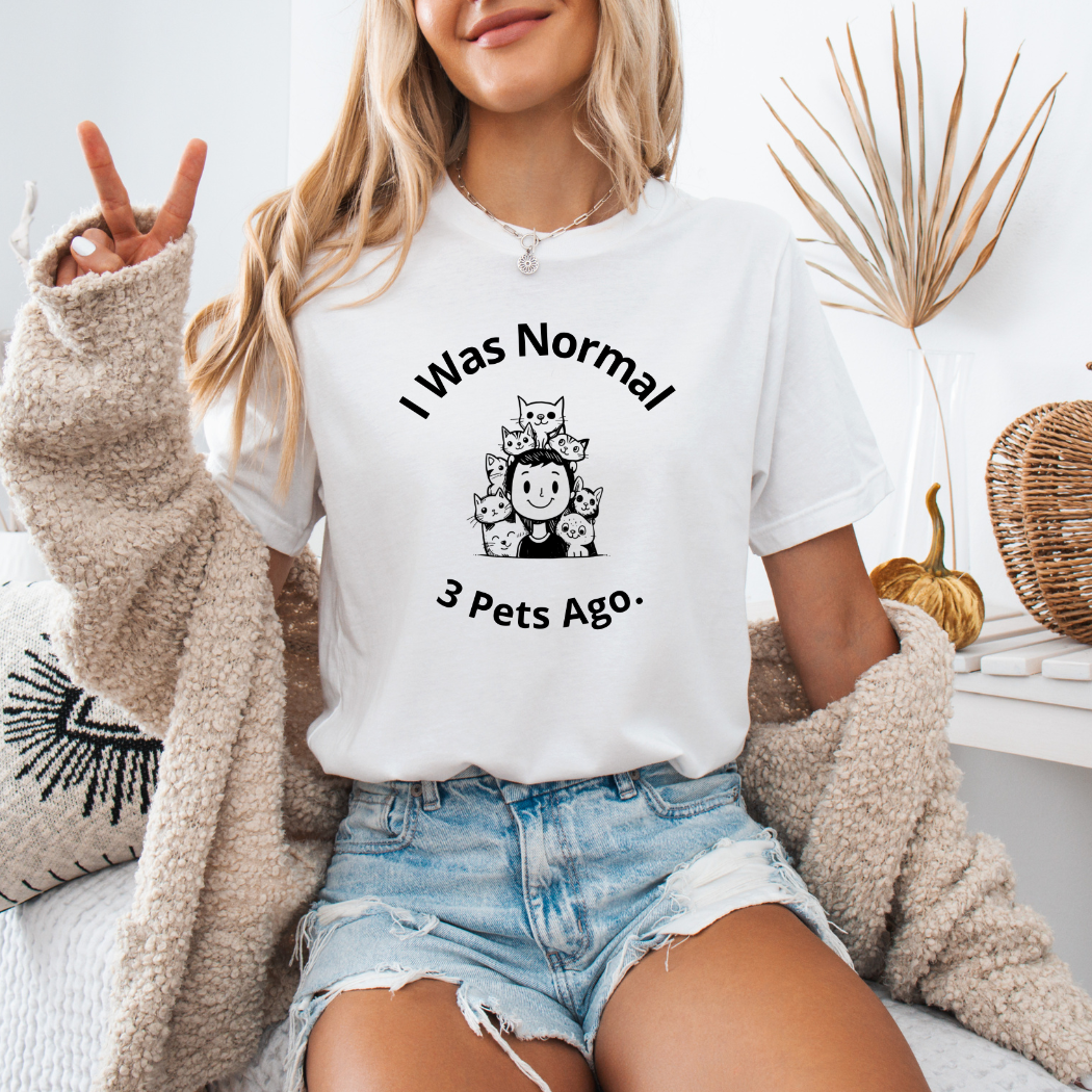 a woman sitting on a bed wearing a t - shirt that says i was normal