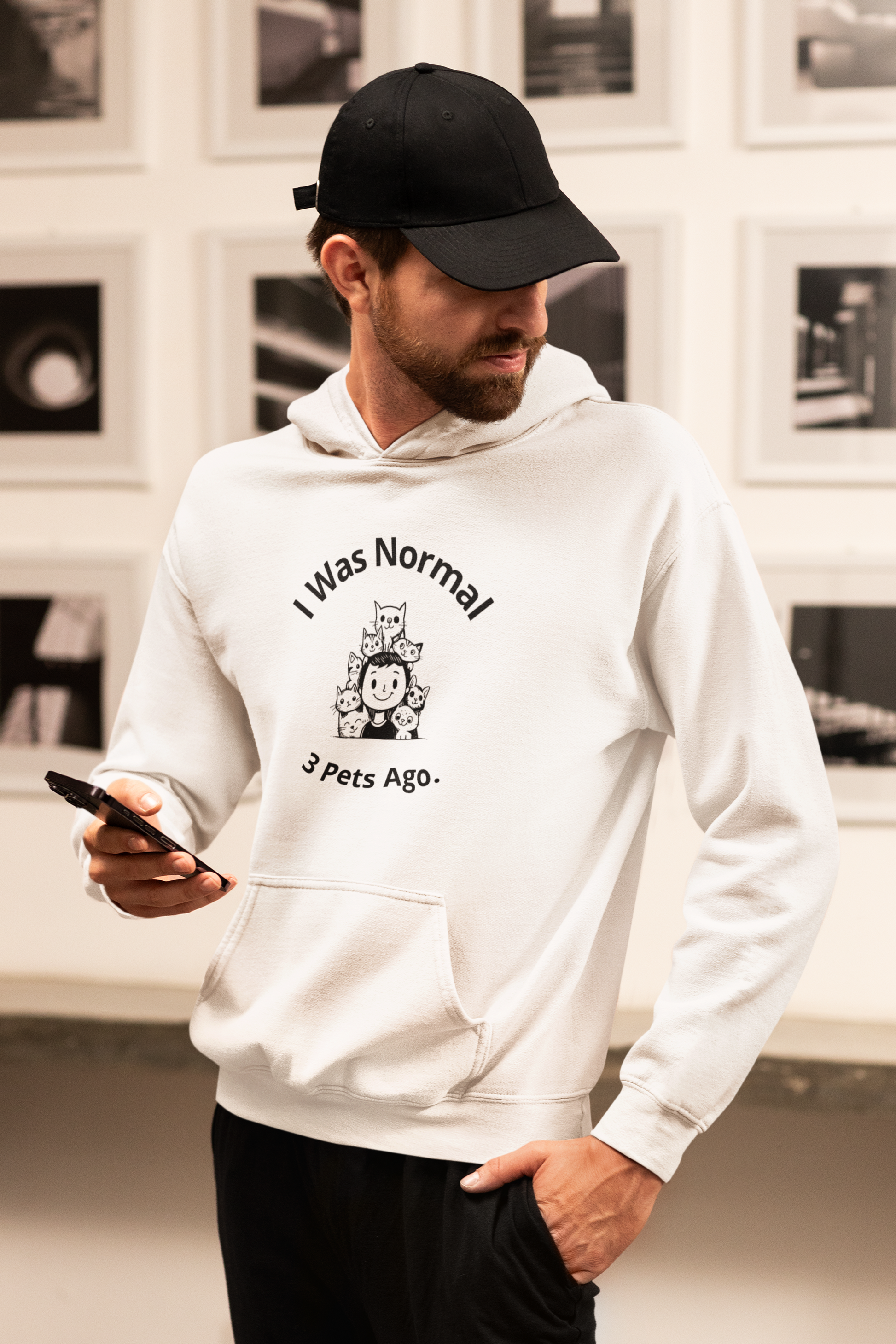 a man in a white hoodie looking at his cell phone