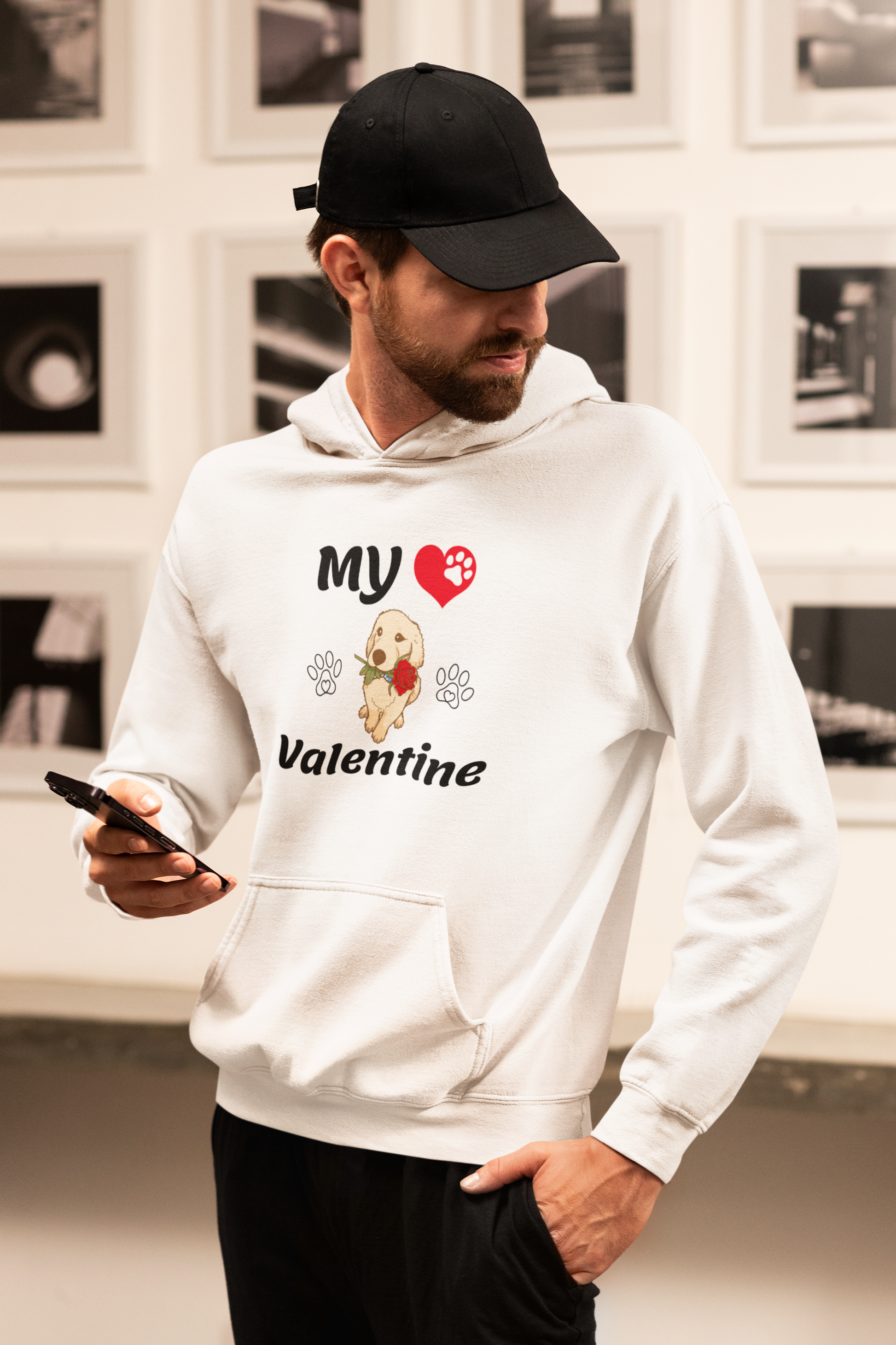 a man in a white hoodie holding a cell phone