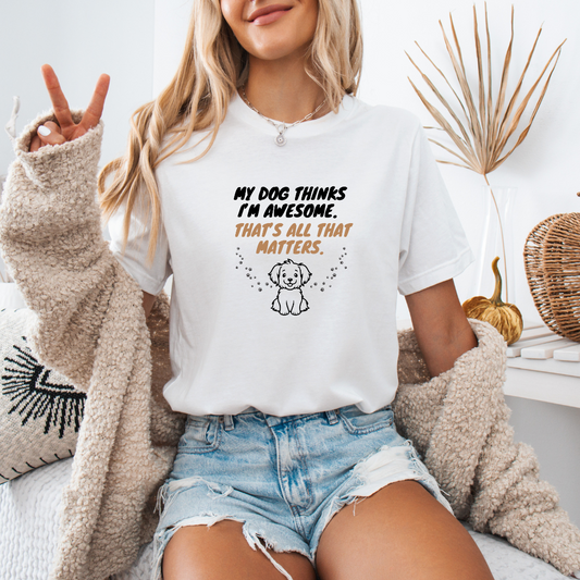 a woman sitting on a bed wearing a t - shirt that says, my dog