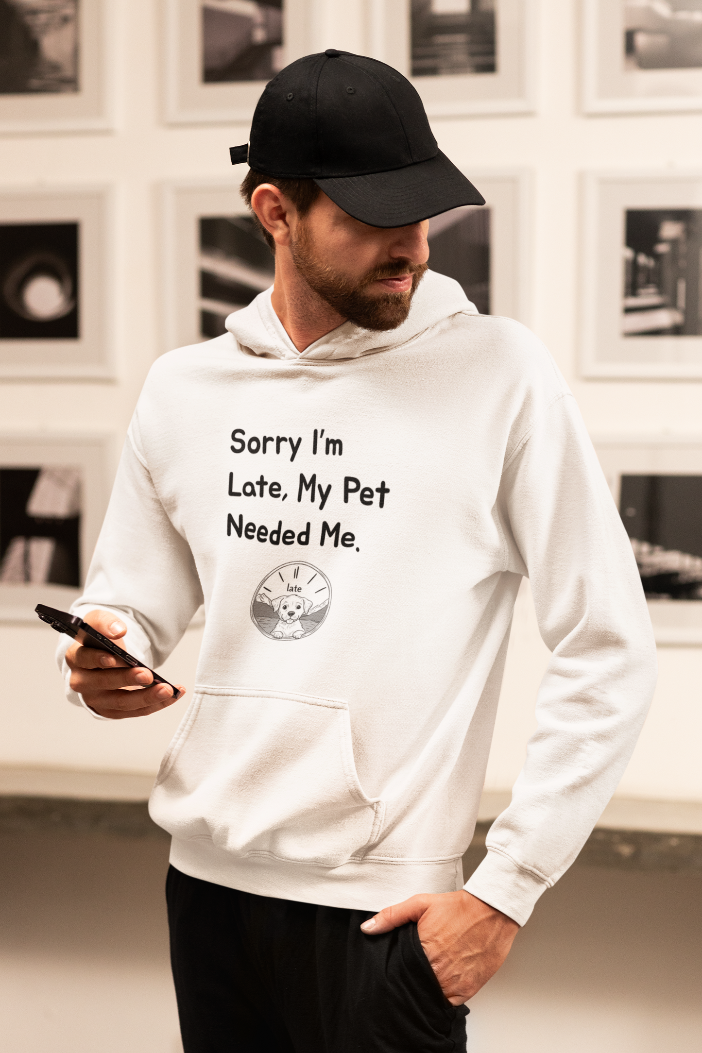 a man in a white hoodie holding a cell phone