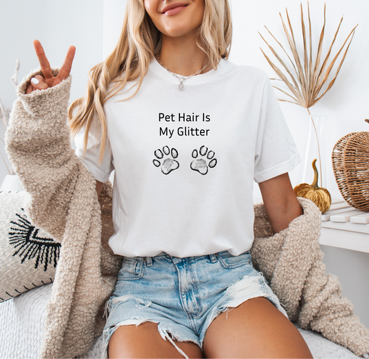 a woman sitting on a bed wearing a t - shirt that says pet hair is